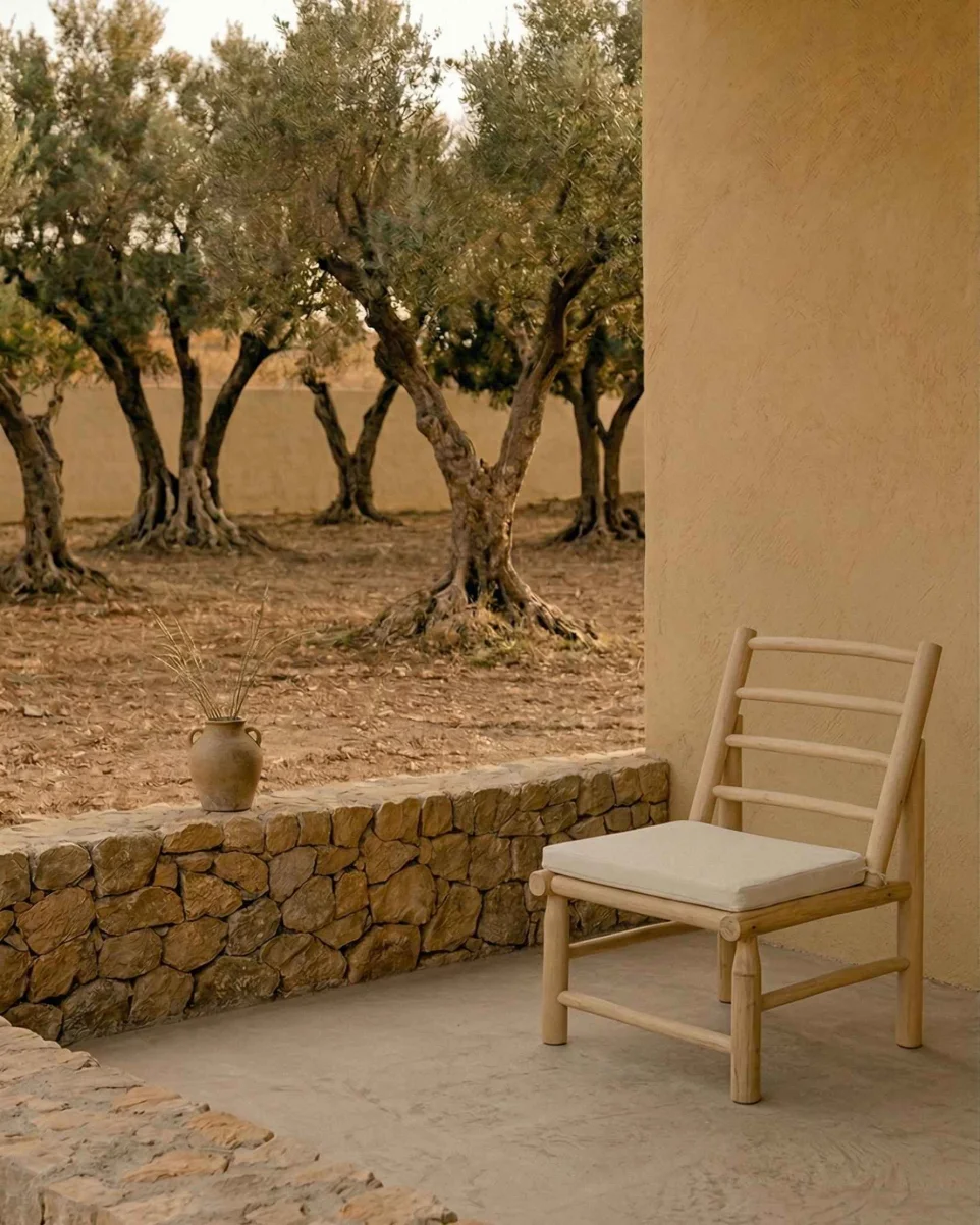 Silla Dina de madera de teca con cojín blanco en terraza de estilo mediterráneo